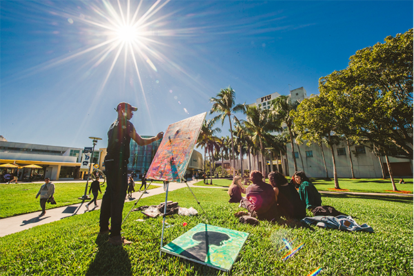 Student painting on the GC lawns