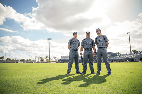 Three baseball players posing for a portrait.