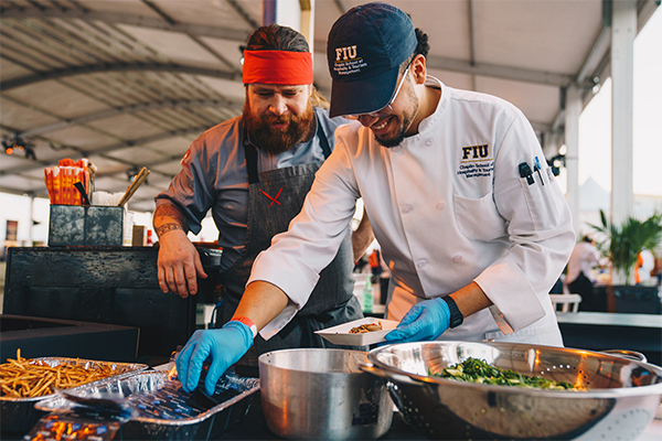 An FIU student preparing food at the SOBE food and wine festival